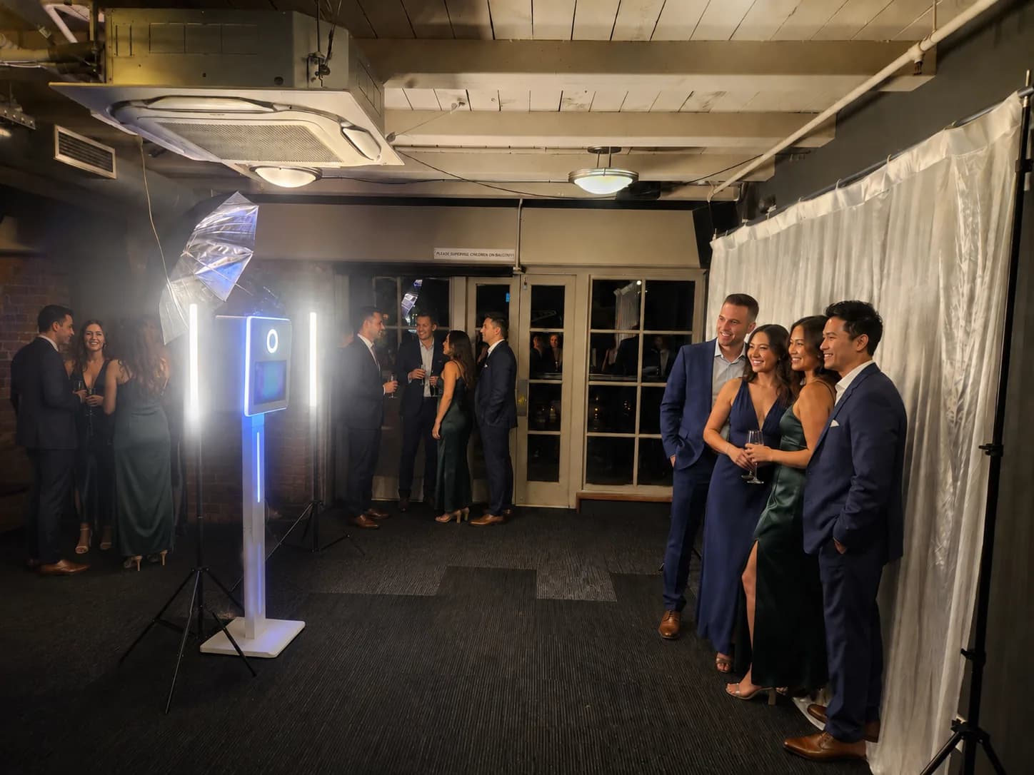 Guests using the PhotoBoothPro booth at a formal Wellington event