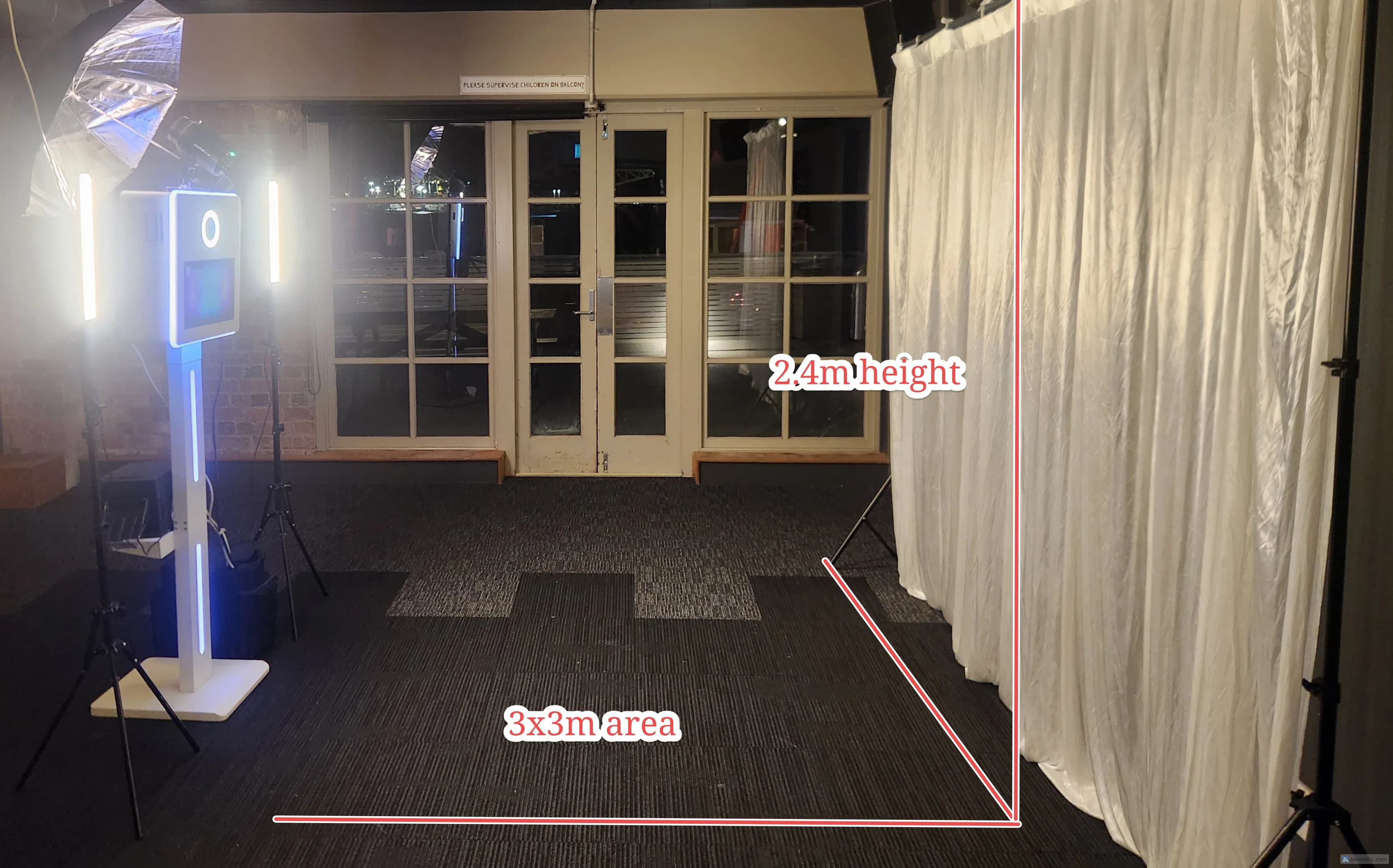 PhotoBoothPro booth, backdrop and lighting arranged inside a venue